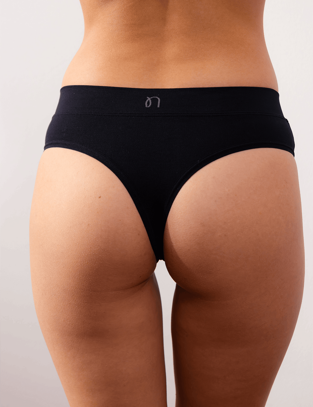 Black light thong panties with low-rise cut and narrow front panel