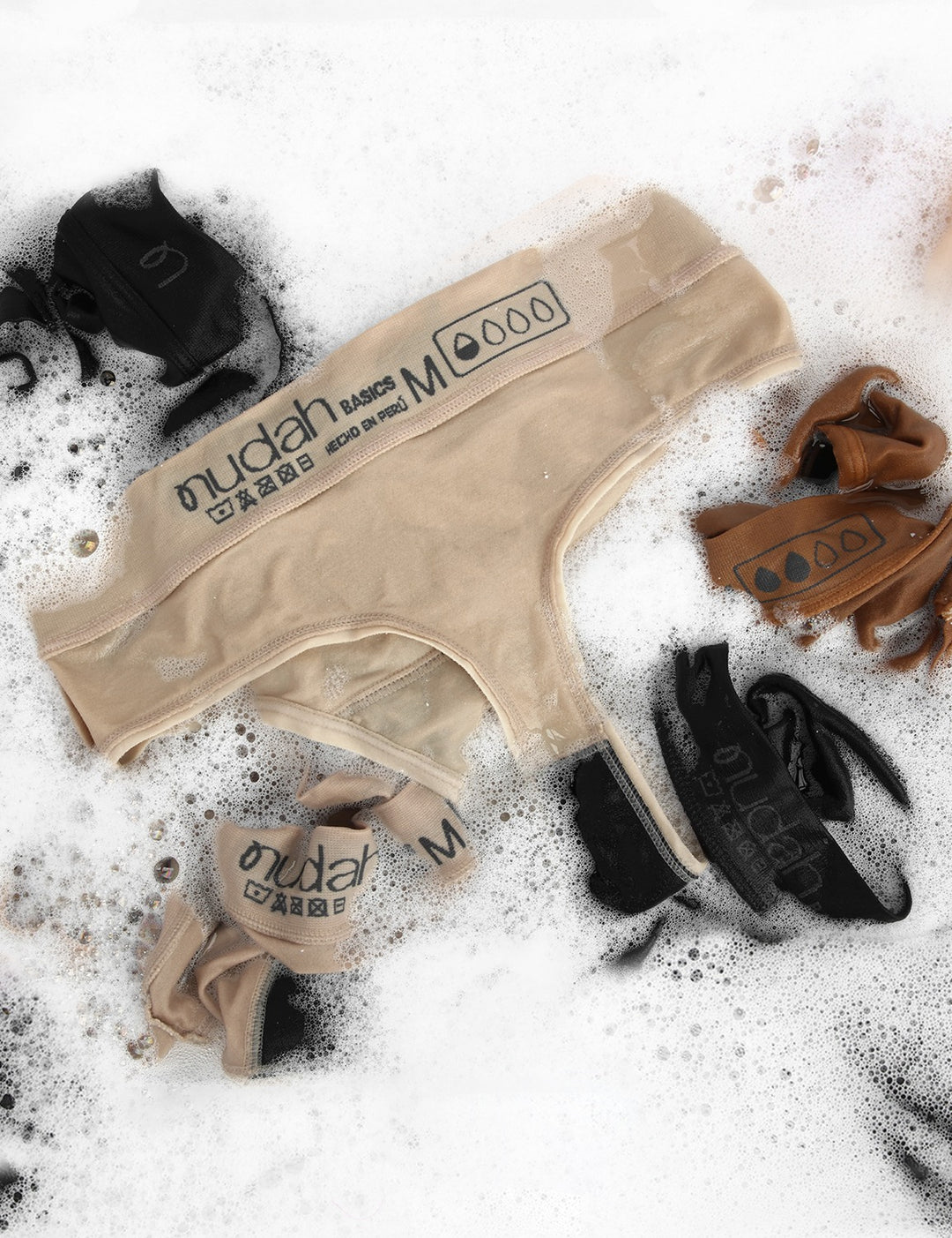 Beige and black moderate coverage bikini briefs with brand labels and tags