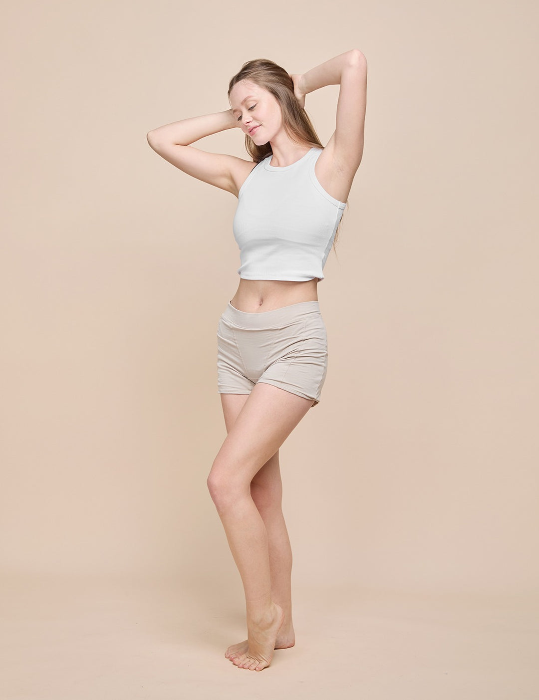 Beige heavy absorbency short on model, side view
