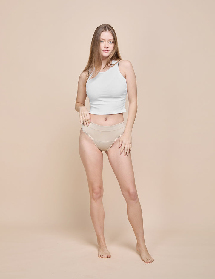 Model wearing the beige light absorbency thong, front view
