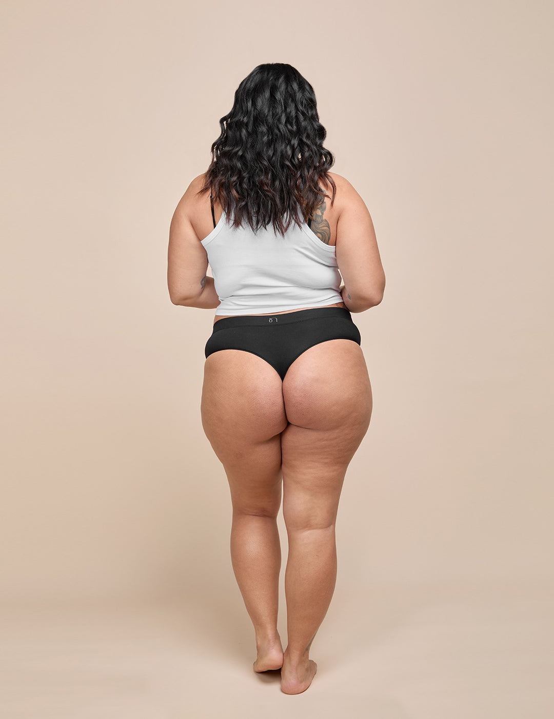 Model wearing the black light absorbency thong, back view